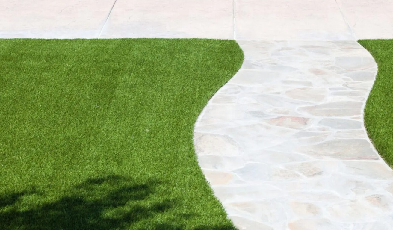 Beautiful artificial grass walkway with stone pavers in Southaven, MS